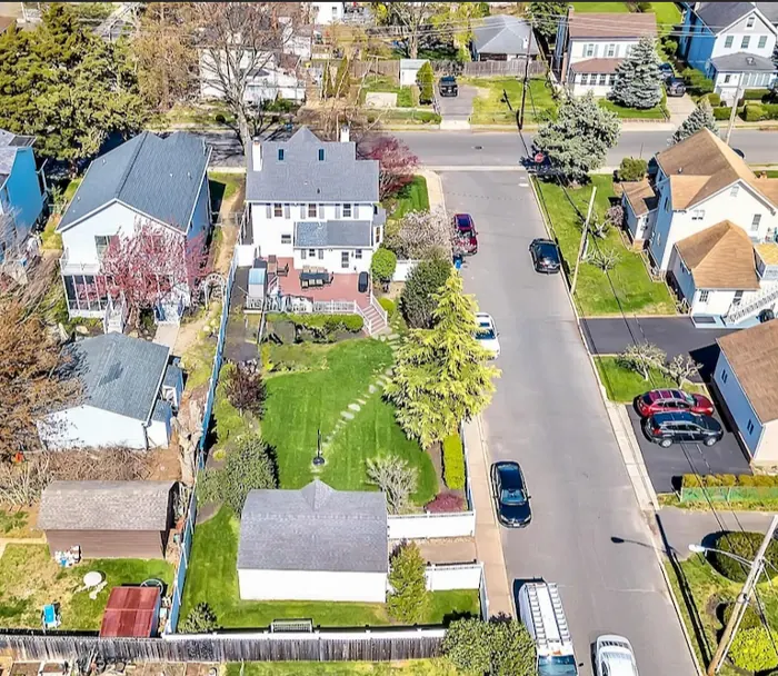 Aerial view of the house, deck, and yard